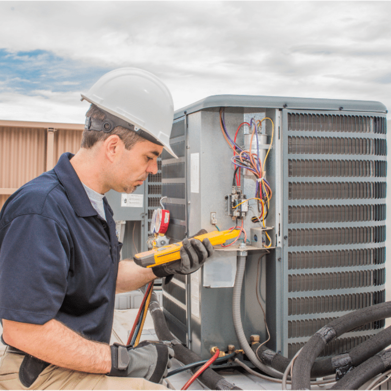 Caledonia Heating & Cooling HVAC technician servicing a system